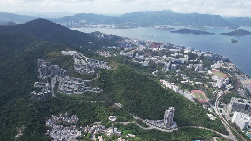 Aerial tour over the exclusive low-density villa estates and luxury residences nestled on the slopes of Hong Kong Kau To Shan near Sha Tin CUHK