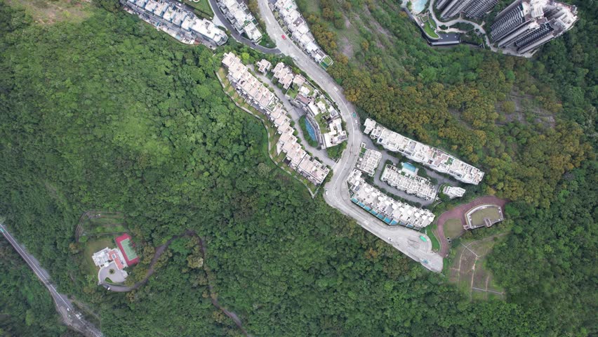 Aerial tour over the exclusive low-density villa estates and luxury residences nestled on the slopes of Hong Kong Kau To Shan near Sha Tin CUHK