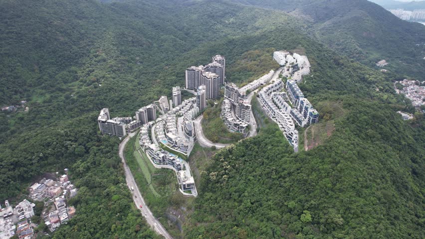 Aerial tour over the exclusive low-density villa estates and luxury residences nestled on the slopes of Hong Kong Kau To Shan near Sha Tin CUHK