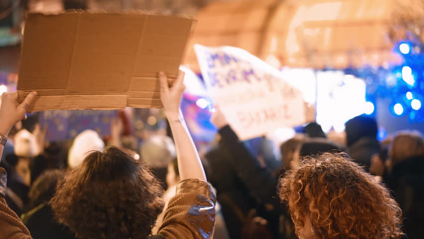 Feminist protester walk city night. 8 march day feminism protest. Many demonstration banners. Woman riot anti violence. Female rights picket. Girl power fight. People rebels hold carry strike placard.