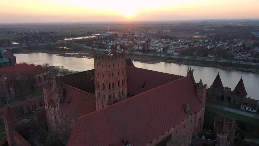 Malbork castle over the Nogat river at sunset, Poland