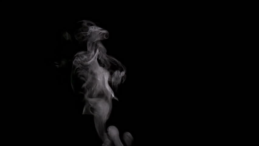 Steam Rises From the Cup. White smoke on black background. Slow Motion
