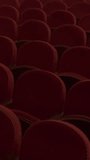 Red seats in an empty cinema hall. Dark auditorium with rows of soft chairs. Vertical video. - Powered by Shutterstock - Get 15% off with code: PIKWIZARD15