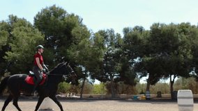 Professional female jockey rides on horseback. Horse runs on the sand . Slow motion video