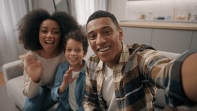 Happy family African American man woman male female parents little boy child kid son looking camera online phone smartphone mobile video call chat app talking waving hands gesture greeting indoor room - Powered by Shutterstock - Get 15% off with code: PIKWIZARD15