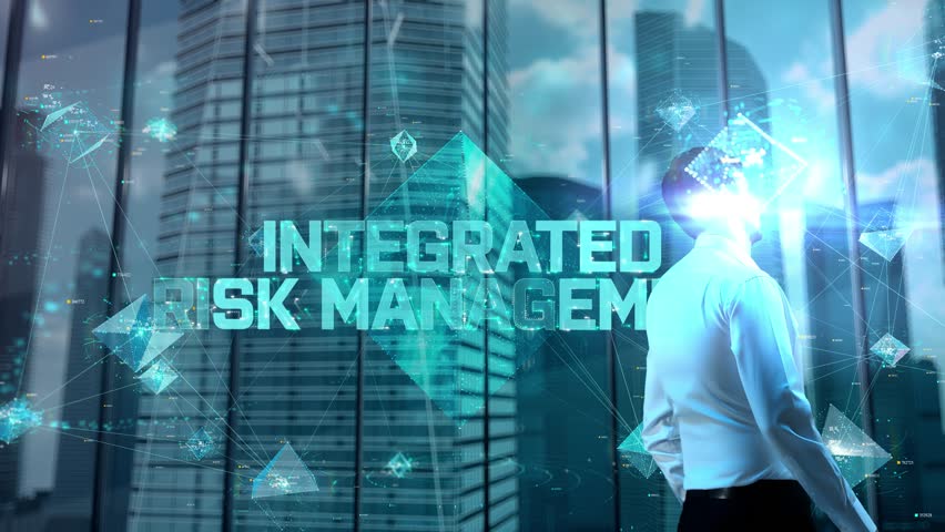 Integrated Risk Management. Businessman Working in Office among Skyscrapers. Hologram Concept