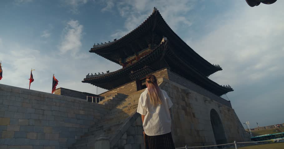Korean Woman Stands in front of Janganmun Gate at Suwon-si in South Korea