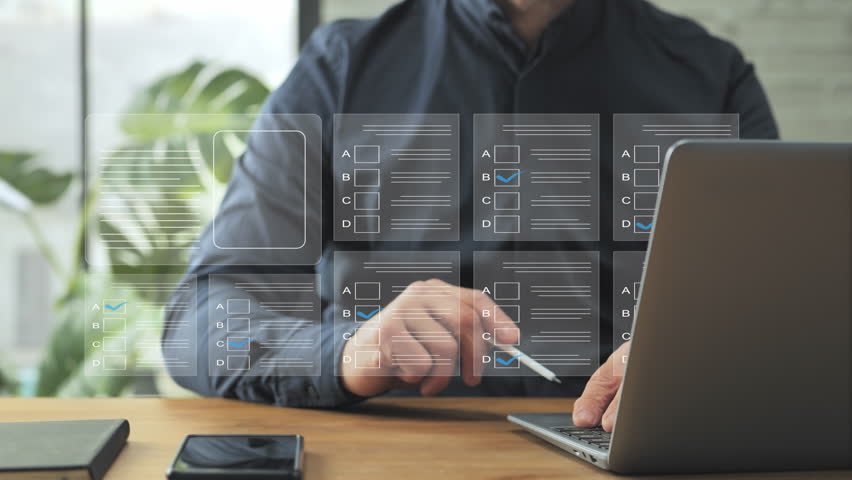 online assessment test man at laptop computer gets certification,male sits at the desk at home fills questionnaire checklist,answers questions,business quality certificate evaluation