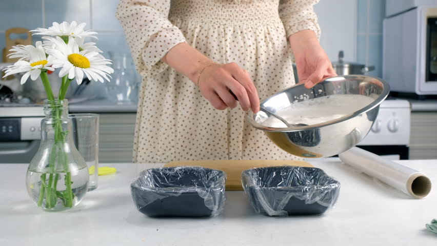Woman cooking putting marshmallows mass to solidify in baking sheet on kitchen. Culinary cuisine baking food dish pastry. Preparing sweet homemade marshmallows apple dessert.