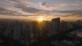 Aerial view shows the sunrise over the lively cityscape of Manila, Philippines, casting warm hues on the skyline and picturesque sky - Powered by Shutterstock - Get 15% off with code: PIKWIZARD15