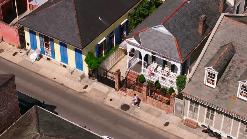 Vibrant aerial view of a colorful New Orleans street scene, showcasing an african american man walking and the city