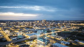 Aerial view captures the bustling cityscape of downtown Birmingham, data and graphic overlay and augmented reality. City lights illuminate buildings and streets with cloudy sky above - Powered by Shutterstock - Get 15% off with code: PIKWIZARD15