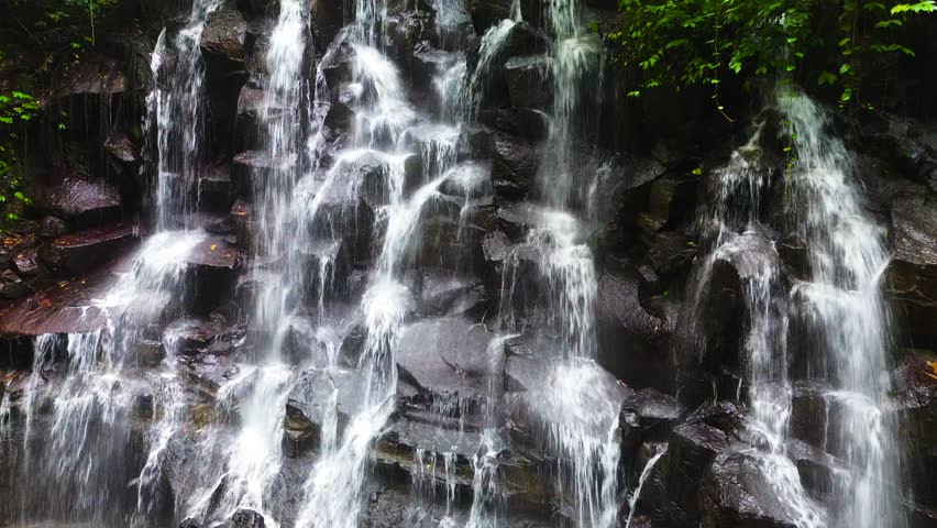 Kanto Lampo, a big cascade waterfall with a shallow pool and a bat cave nearby, Bali, Indonesia
