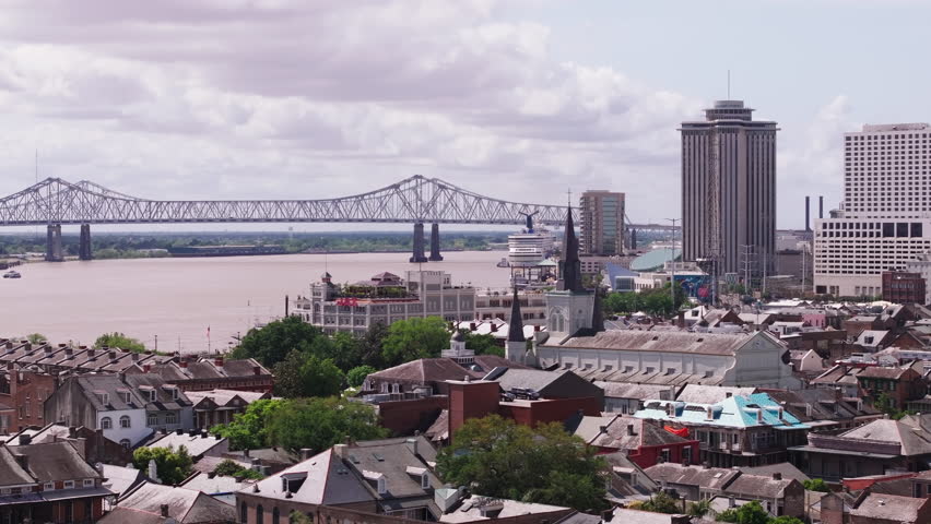 New Orleans skyline with the iconic mississippi river and Crescent City Connection bridge. Discover historic architecture and vibrant colors in a urban landscape