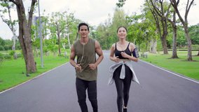 Asian couple in sportswear jogging exercise at public park together in summer morning. Healthy man and woman athlete enjoy outdoor activity lifestyle sport training fitness running workout in the city - Powered by Shutterstock - Get 15% off with code: PIKWIZARD15