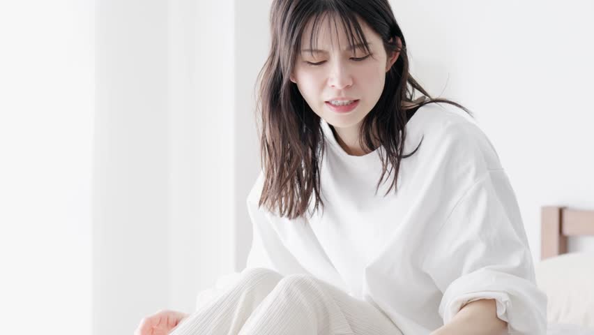 Woman blowing her nose in the room