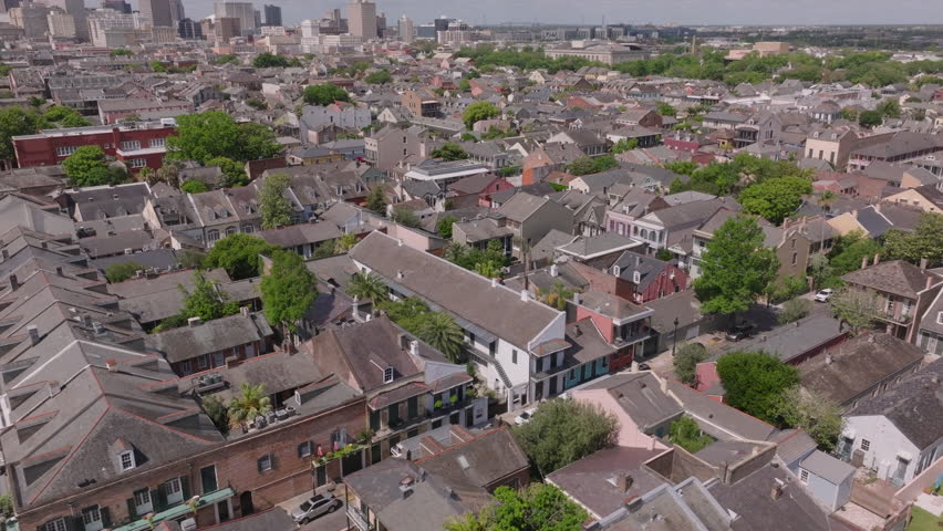 The charm of a historic residential neighborhood in the French Quarter of New Orleans from above, showcasing its unique architecture and distant cityscape views