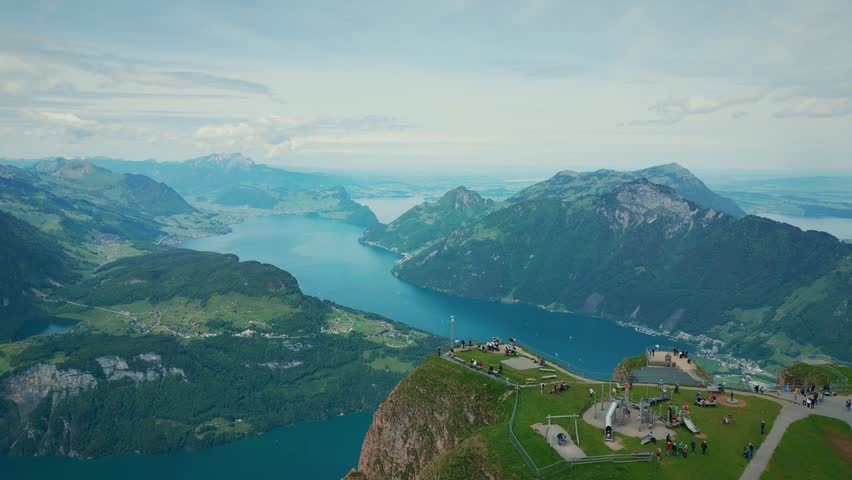 Picturesque view of lake Lucerne and Fronalpstock in Switzerland, aerial view. Drone flying over lake with turquoise water surrounded by green mountain hills in Swiss Alps