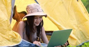 woman lying using laptop while they having camping in morning. 4k video