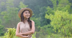 young woman standing cross your arms in the nature, 4k video