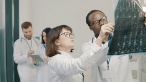 Doctors discussing medical x-ray in clinic - Powered by Shutterstock - Get 15% off with code: PIKWIZARD15