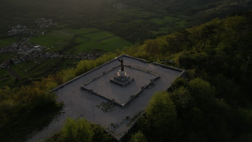 Drone Aerial Wide view of Statue of Saint Francesco near the Basilica of Sveta Gora on the Mountain over Gorizia and Nova Gorica Cities on the Slovene Italian Border