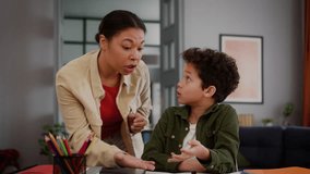 African American family little boy child kid son pupil studying home education homework learning study problem tired boring sad angry mother woman female mom come in room talking dissatisfied scold - Powered by Shutterstock - Get 15% off with code: PIKWIZARD15