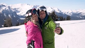Happy skier couple taking selfie on sunny mountain ski resort - Powered by Shutterstock - Get 15% off with code: PIKWIZARD15