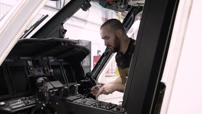 Technician working in helicopter cockpit