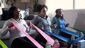 Mature women friends exercising with resistance bands at home - Powered by Shutterstock - Get 15% off with code: PIKWIZARD15