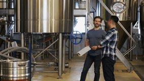 Male brewers talking near distillation tanks in brewery - Powered by Shutterstock - Get 15% off with code: PIKWIZARD15