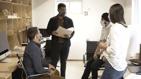 Startup business team wearing facemask having meeting in workspace - Powered by Shutterstock - Get 15% off with code: PIKWIZARD15