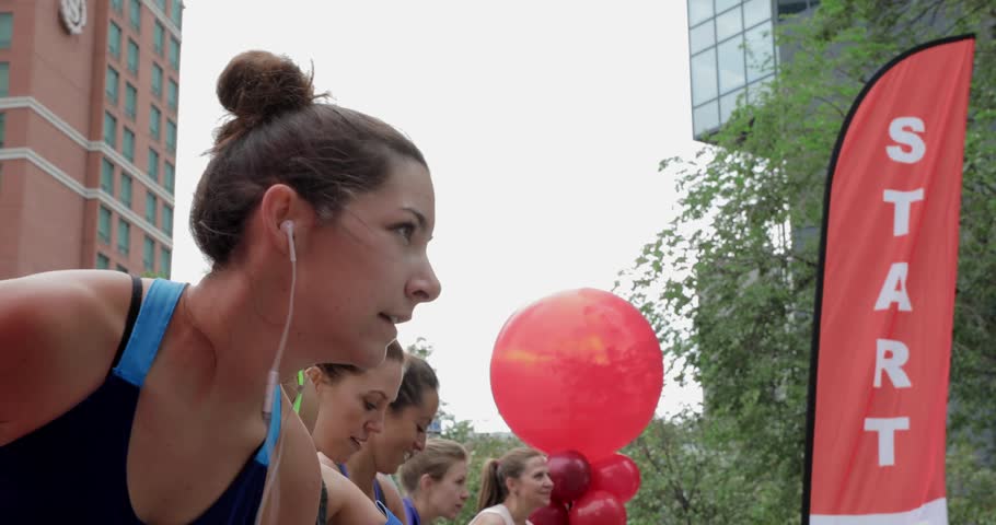 Ready marathon runners at starting line on urban street