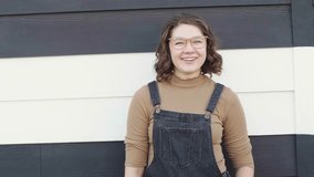 Portrait happy beautiful young woman laughing at striped wall - Powered by Shutterstock - Get 15% off with code: PIKWIZARD15