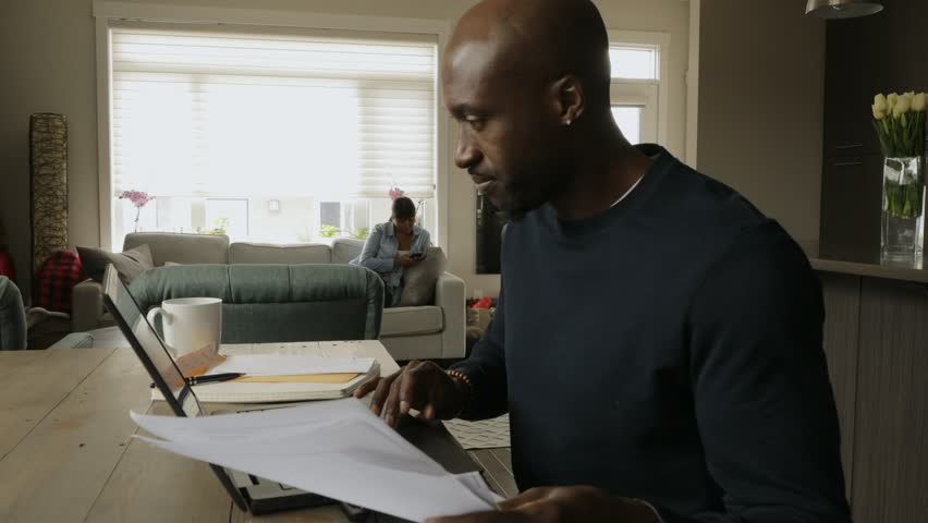 Man paying bills at laptop