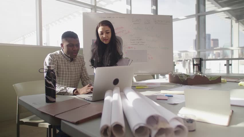 Land use planners meeting at laptop in community center