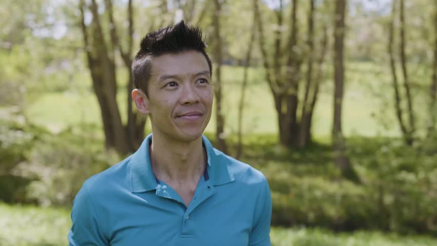 Slow motion of cheerful mature man in park