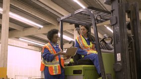 Forklift driver and worker discussing work in distribution warehouse - Powered by Shutterstock - Get 15% off with code: PIKWIZARD15