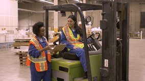 Forklift driver and worker discussing work in distribution warehouse - Powered by Shutterstock - Get 15% off with code: PIKWIZARD15