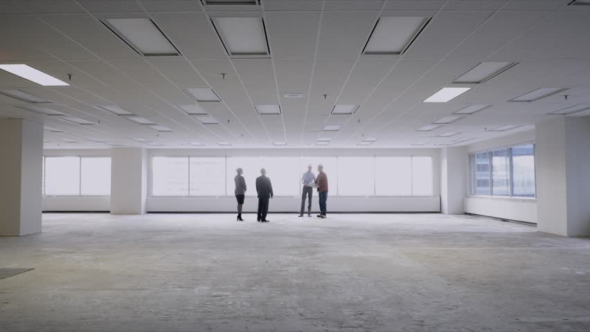 Architects contractor and business people meeting in unfurnished empty open plan office - Powered by Shutterstock - Get 15% off with code: PIKWIZARD15