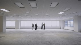 Architects contractor and business people meeting in unfurnished empty open plan office - Powered by Shutterstock - Get 15% off with code: PIKWIZARD15