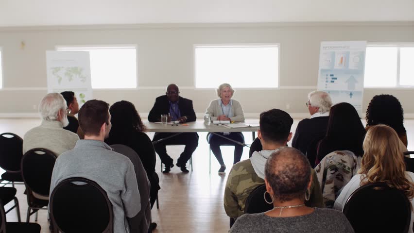 Community asking questions of community leaders in town hall meeting