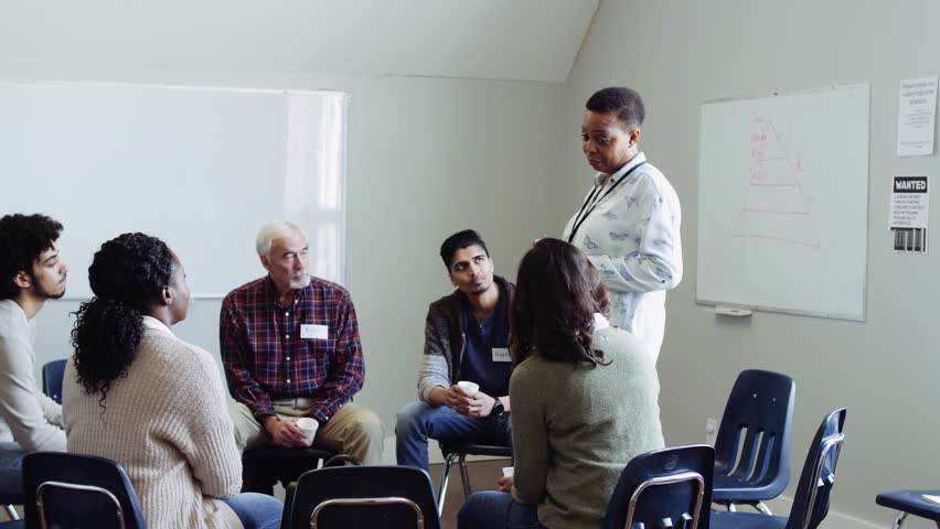 Woman leading support group meeting in community center