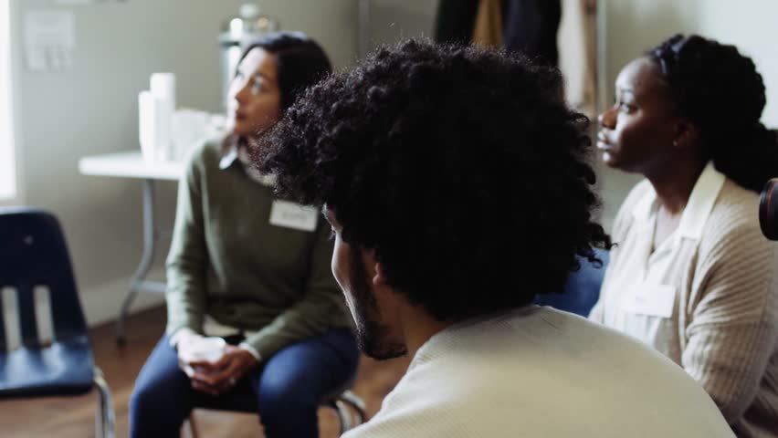 Woman leading support group meeting in community center