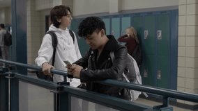 High school boy students using smart phone at railing - Powered by Shutterstock - Get 15% off with code: PIKWIZARD15