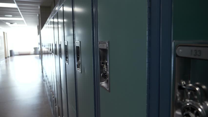Blue lockers with padlocks in a row in high school corridor