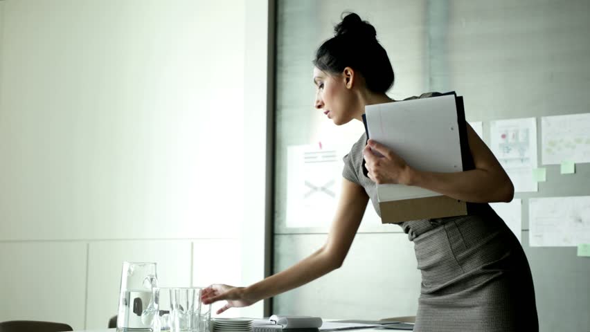Businesswoman preparing for meeting in conference room