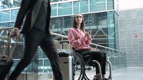 Businesswoman in wheelchair with smart phone and suitcase in airport - Powered by Shutterstock - Get 15% off with code: PIKWIZARD15