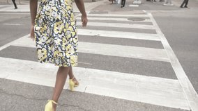Stylish woman in yellow high heels and skirt walking in city crosswalk - Powered by Shutterstock - Get 15% off with code: PIKWIZARD15