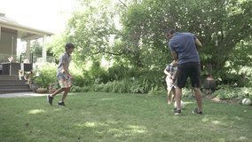 Slow motion of man and sons playing soccer in backyard - Powered by Shutterstock - Get 15% off with code: PIKWIZARD15